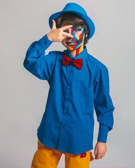 Child in vibrant face paint and stylish attire posing creatively.
